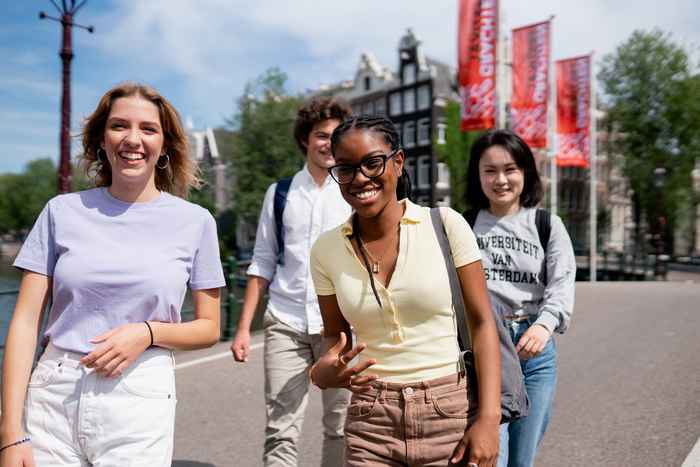 Students walking on a bridge in Amsterdam city center